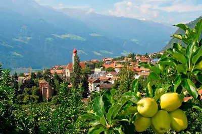 a town on a hill with a village in the background at Fruemess - Historic Refugium in Parcines