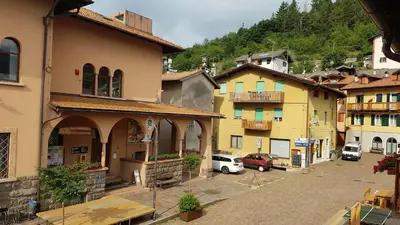 a group of buildings with cars parked in a street at Casa MARGHERITA in Grumes