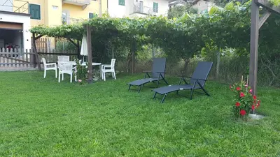 a group of chairs and tables in a yard at Casa MARGHERITA in Grumes