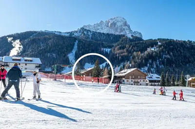 a group of people on skis in the snow at Week End Senoner in Selva di Val Gardena