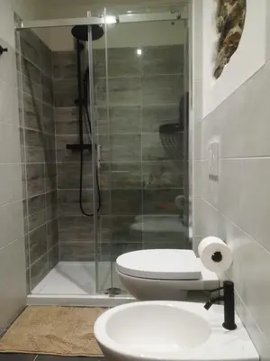 a bedroom with a bed and a desk and a dresser at Camera con bagno privato in Tesero
