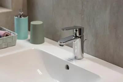a bathroom sink with a chrome faucet on it at KARINA Mulino in Montagna