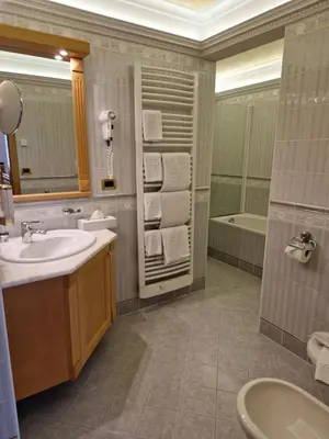 a bathroom with a sink and a tub at Residence Ciastel in Ortisei