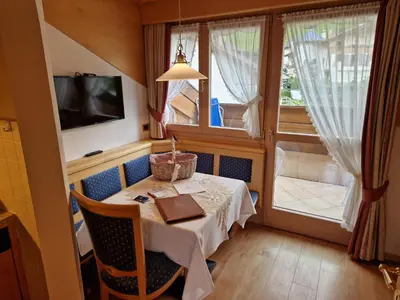 a small dining room with a table and a window at Residence Ciastel in Ortisei