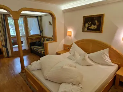 a bedroom with a bed with white pillows at Residence Ciastel in Ortisei