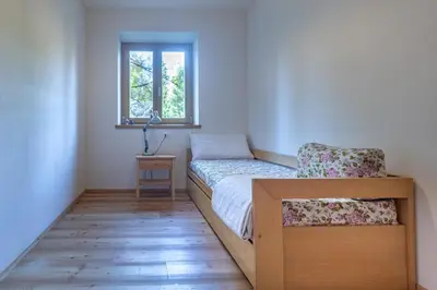 a small bedroom with a bed and a window at Residenza Larici in Bellamonte