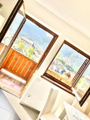 an image of two windows in a house at CASA MARILU' in Castello di Fiemme