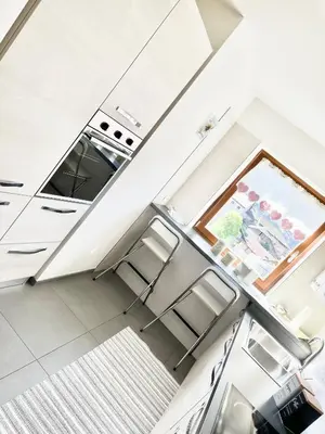 an overhead view of a kitchen with white cabinets at CASA MARILU' in Castello di Fiemme