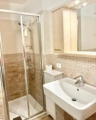 a bathroom with a sink and a shower at CASA MARILU' in Castello di Fiemme