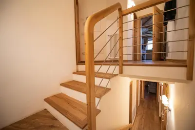 a staircase in a tiny house with wooden floors at Cristina Hospitality in Ortisei