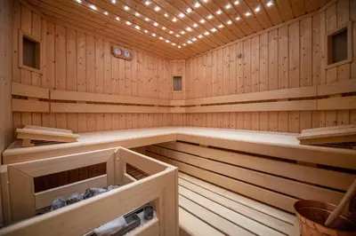 a wooden sauna with lights on the ceiling at Cristina Hospitality in Ortisei