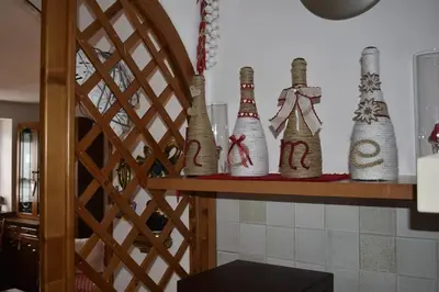 a group of bottles sitting on a shelf at Casa Amabile in San Vito di Cadore