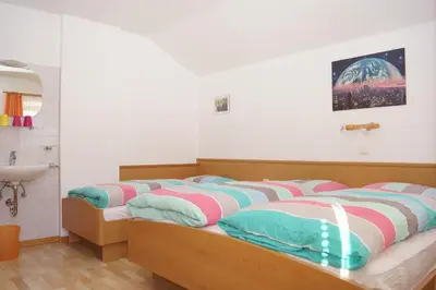 a bedroom with two beds and a sink in it at Appartment Felder Erika in Valdaora