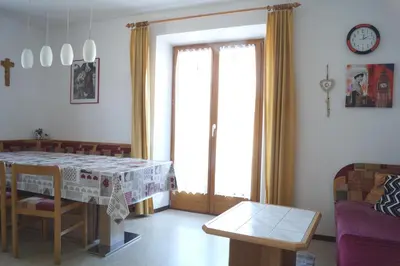 a living room with a table and a couch at Appartment Felder Erika in Valdaora