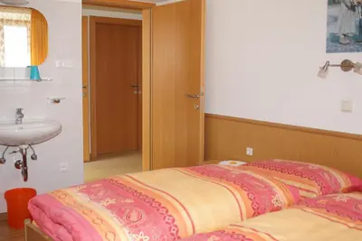 a bedroom with a bed and a sink in it at Appartment Felder Erika in Valdaora