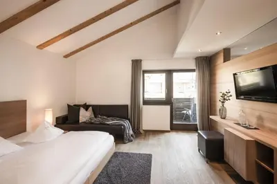 a hotel room with a bed and a television at Hotel Gasthof Wieser in Petersberg