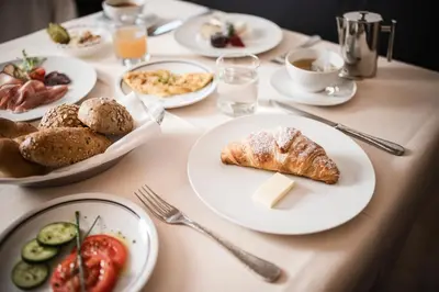 a table with plates of food on it at Hotel Gasthof Wieser in Petersberg