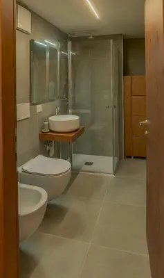 a bathroom with a toilet and a sink and a shower at Appartamento con terrazza vista Pale di San Martino in San Martino di Castrozza