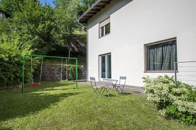 a yard with a swing set in the grass at Villa Vastle in Ortisei
