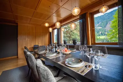 a dining room with a long table and chairs at Villa Vastle in Ortisei
