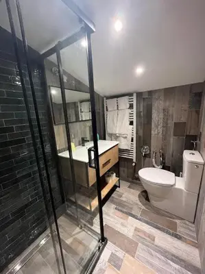 a bathroom with a toilet and a sink and a shower at Casa Karin in Canazei