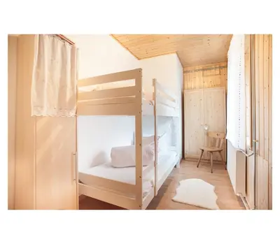 a bedroom with a bunk bed with a ladder at Apartment Toni in Sarntal