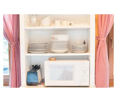 a white microwave oven sitting inside of a kitchen at Apartment Toni in Sarntal