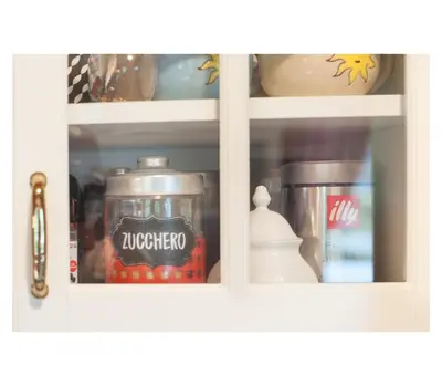 a white cabinet with food items in it at Apartment Toni in Sarntal