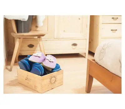 a wooden box with two pink shoes on top of it at Apartment Toni in Sarntal