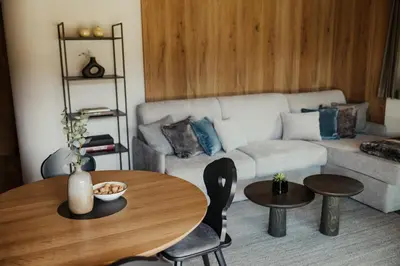 a living room with a table and a couch at Apartments Villa Sofia in Santa Cristina in Val Gardena