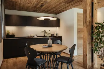 a kitchen and dining room with a table and chairs at Apartments Villa Sofia in Santa Cristina in Val Gardena