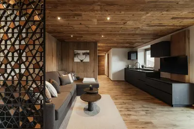 a living room with a couch and a kitchen at Apartments Villa Sofia in Santa Cristina in Val Gardena