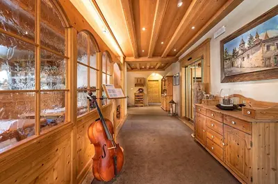 a hallway with a violin hanging on the wall at Hotel Schallerhof in Tesimo