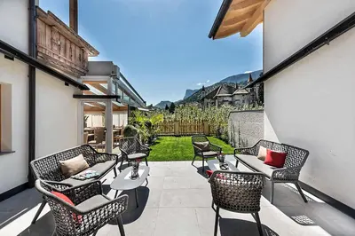 a group of chairs and tables on a patio at Hotel Schallerhof in Tesimo