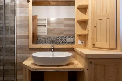 a bathroom with a white sink and a shower at SUITE203 in Noàc