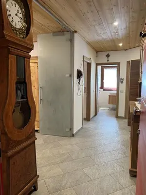a hallway with a grandfather clock in a room at SUITE203 in Noàc