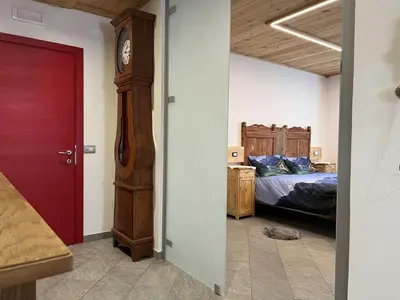 a bedroom with a bed and a grandfather clock at SUITE203 in Noàc