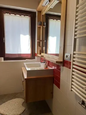 a bathroom with a sink and a mirror at SUITE203 in Noàc