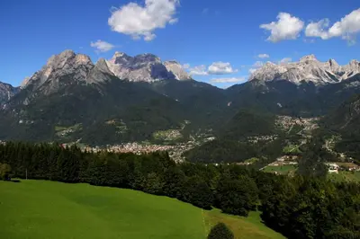 a view of a green field with mountains in the background at SUITE203 in Noàc