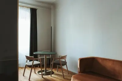 a room with a table and chairs and a couch at Arthotel Lasserhaus in Bressanone