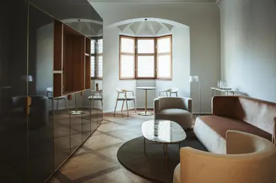 a living room with a couch and a table at Arthotel Lasserhaus in Bressanone