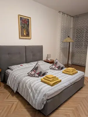 a bedroom with a bed with towels on it at Jolli Mountain in Bolzano