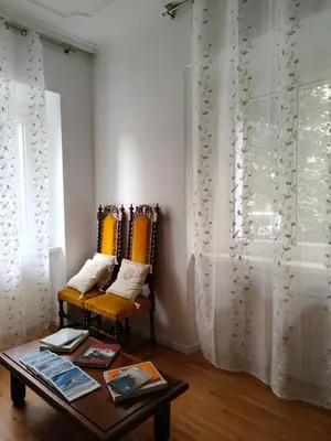 a living room with two chairs and a table at Jolli Mountain in Bolzano