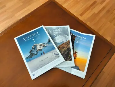 three brochures sitting on top of a table at Jolli Mountain in Bolzano