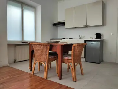 a kitchen with a wooden table and chairs at Jolli Mountain in Bolzano