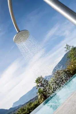 a shower spraying water on the side of a car at Hotel Hofbrunn in Rifiano