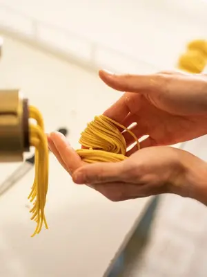 a person holding a bunch of pasta in their hands at Ladurner in Lagundo