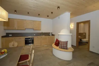 a kitchen with a table and a dining room at Mühlerhof in Funes