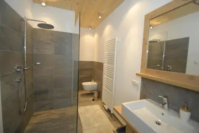a bathroom with a shower and a sink and a toilet at Mühlerhof in Funes