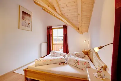 a bedroom with a bed and a window at Angerle Hof in Nova Levante